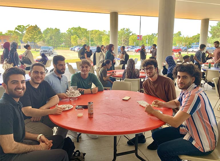 group of Muslim men sitting at table