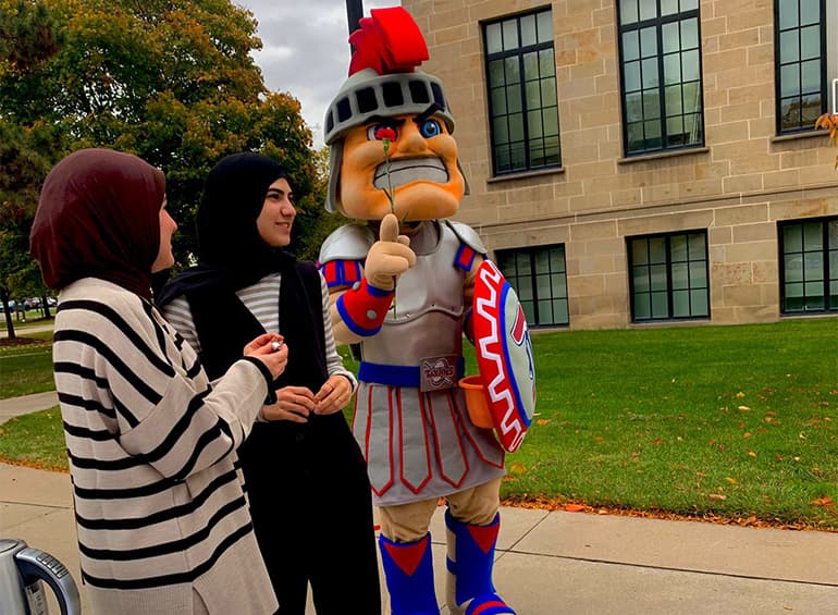 two Muslim women standing with Tommy